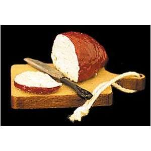   Miniature Rye Bread Sliced with Knife on Bread Board 